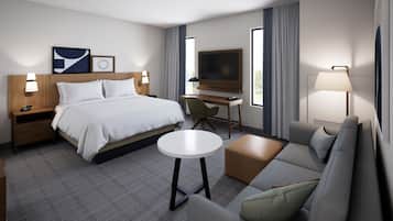 Een moderne hotelkamer met een bed, een bureau, een televisie, een bank en een klein tafeltje.