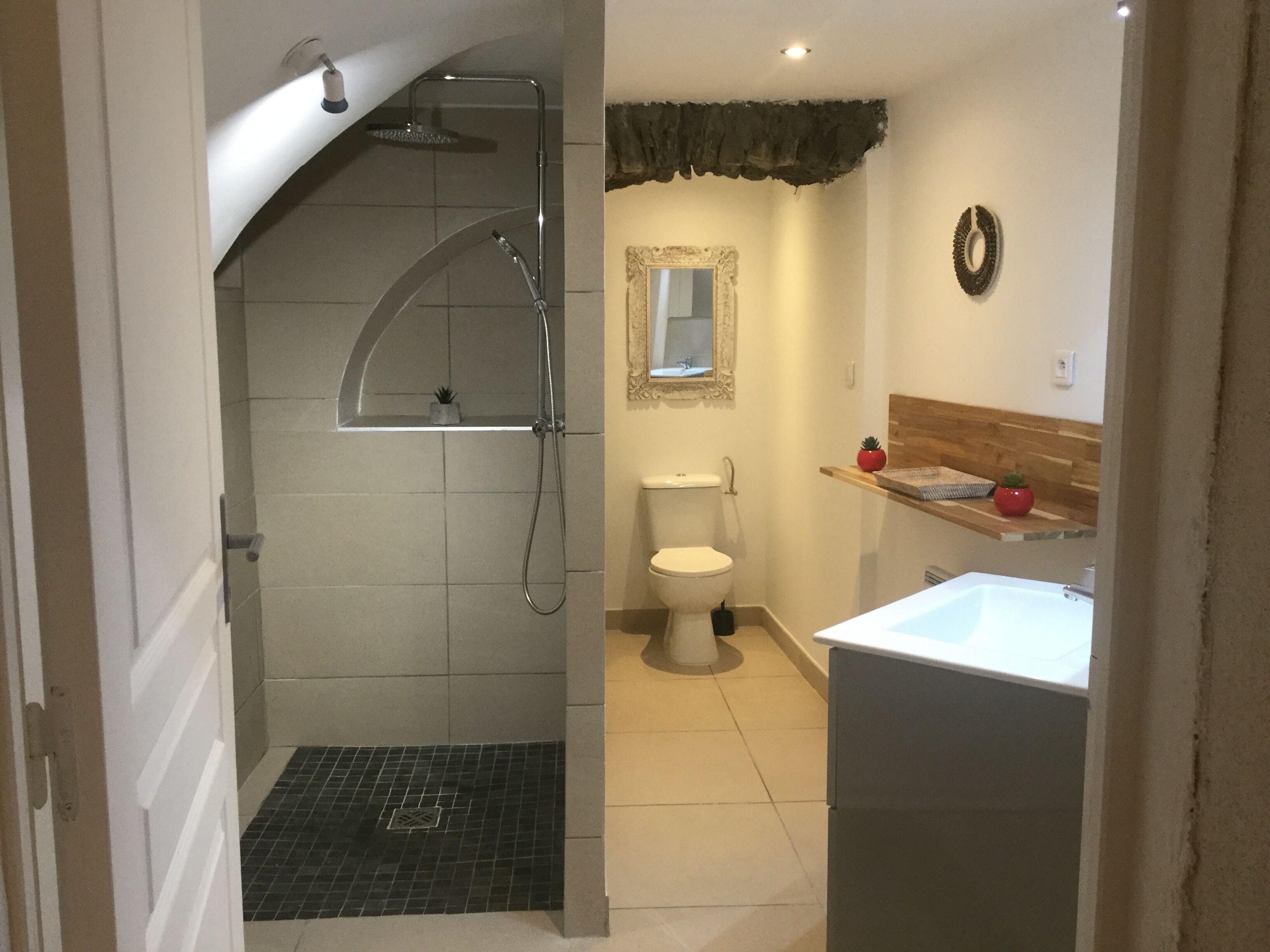 A bathroom with a shower, toilet, and sink.