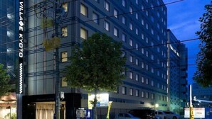 A multi-story hotel with a modern design, featuring a prominent entrance and a visible sign for "EL VILLAGE KYOYO". - Village Kyoto (Kyoto)