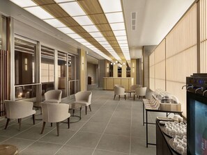 A modern hotel lobby with seating areas, a reception desk, and a buffet setup. - Village Kyoto (Kyoto)