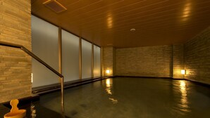 A spacious indoor swimming pool with a wooden floor and walls, a staircase, and a wooden bucket. - Village Kyoto (Kyoto)