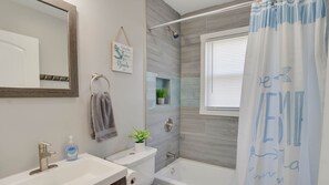 Combined shower/tub, hair dryer, towels, soap