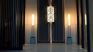 A modern hotel lobby with vertical blinds, a reception desk, and a sign with Japanese characters. - Xi'an Eastern House Boutique Hotel (Xi'an)