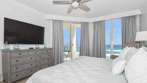 A bedroom with a large bed, a dresser, a flat-screen TV, and a balcony with a view of the ocean. - Updated Beachfront Condo w/ Easy Beach Access at Silver Beach Towers! πβπ΄ (Destin)