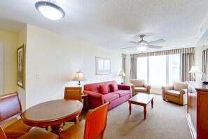 Relax in a comfortable seating area with a sofa, armchairs, and coffee table.