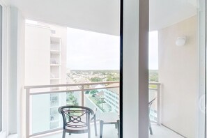 Enjoy a peaceful view of the surrounding neighborhood from this balcony.