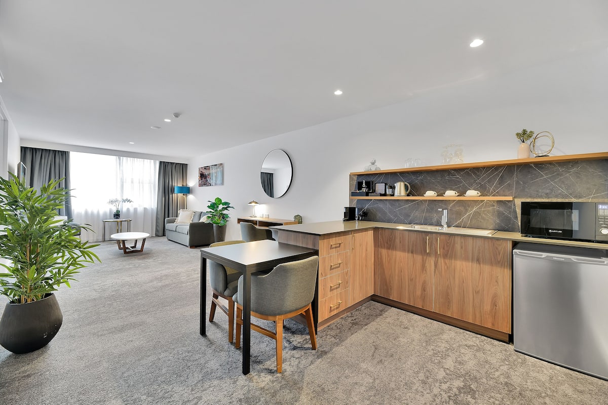 Executive suite (King) | Woonruimte | Een 55-inch smart-tv met kabelzenders en een televisie
