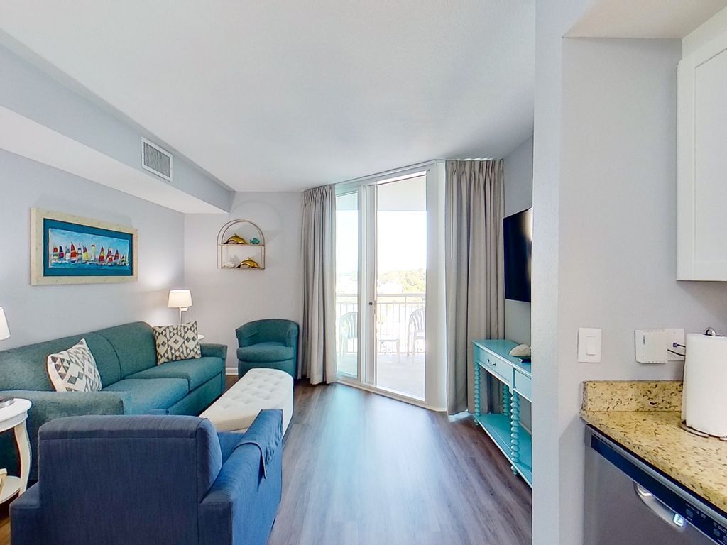 Waterfront condo with heated pool, hot tub, balcony, washer/dryer, & central AC
