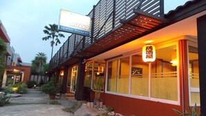 A Japanese restaurant with a red exterior and a signboard. - Eastpana Hotel (Si Racha)