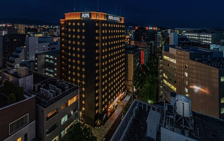 A high-rise hotel with multiple floors, a prominent sign at the top, and a view of the surrounding cityscape.