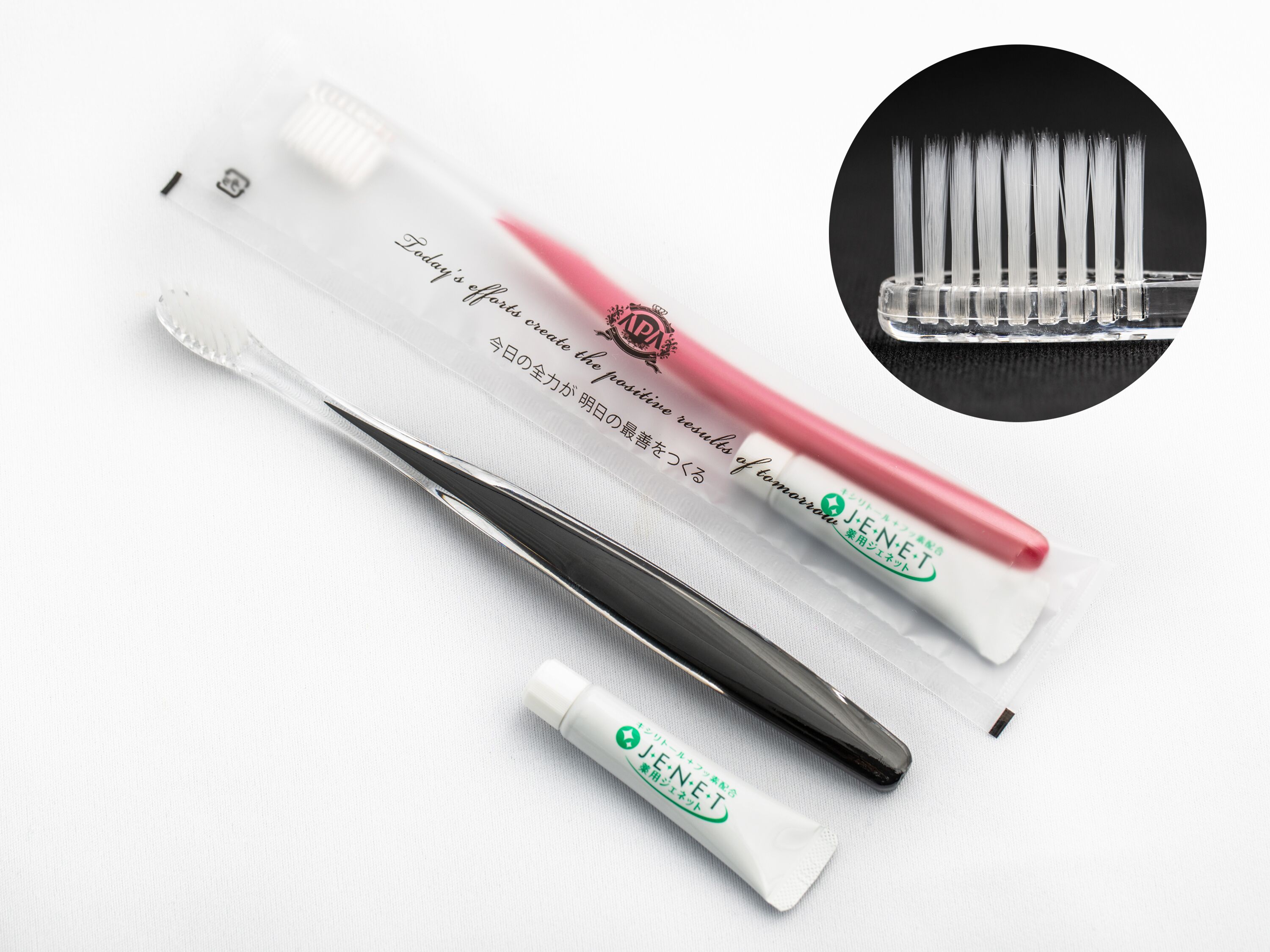 A set of dental tools including tweezers, a probe, and a tube, along with a pair of scissors and a pen.