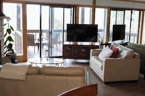 A living room with a sofa, a television, and a table.