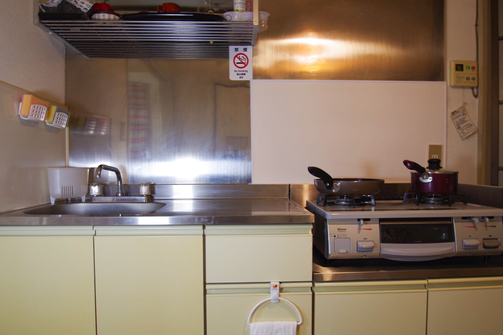 A kitchen with stainless steel appliances, a sink, and a stove.