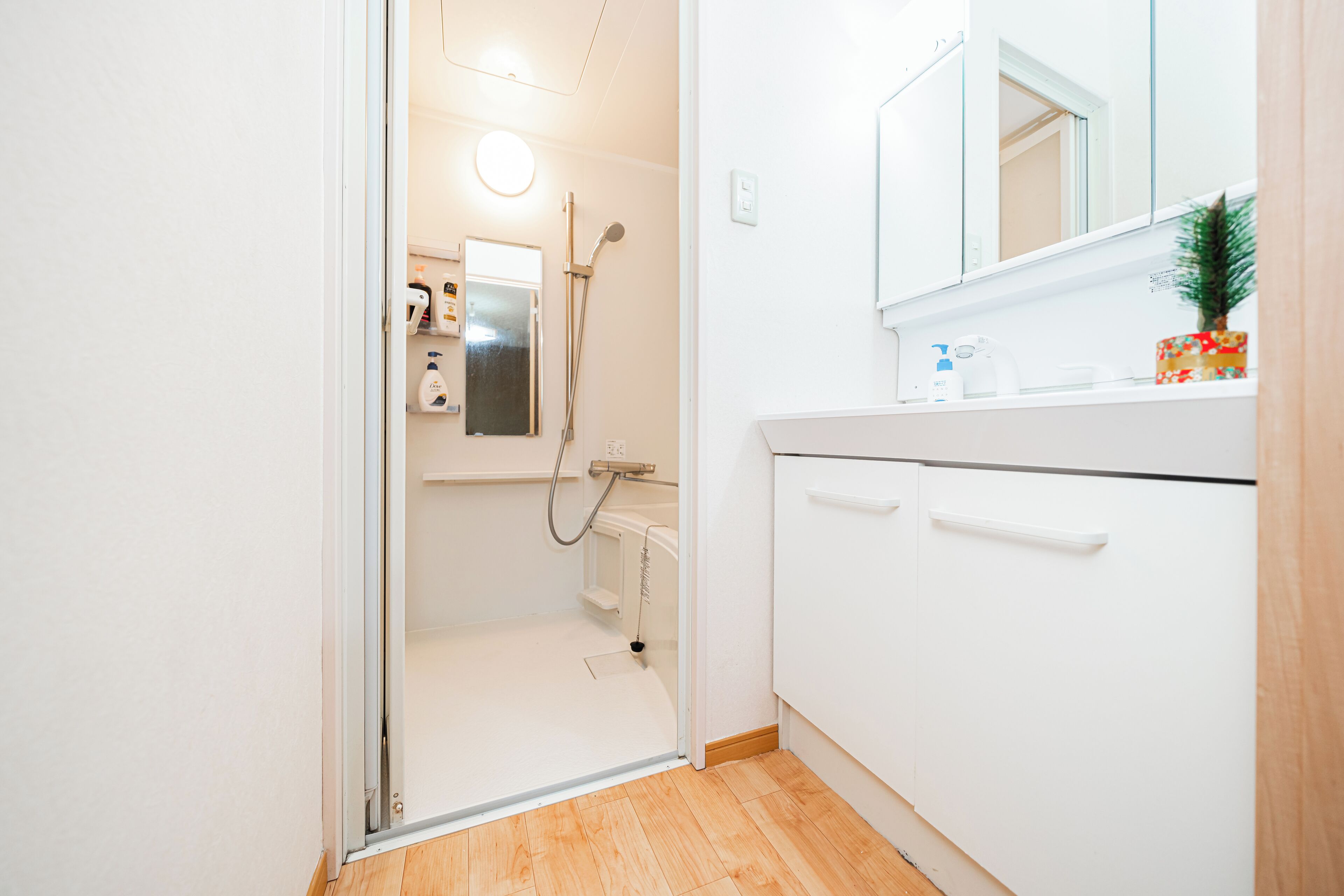 A bathroom with a shower, a toilet, and a sink.