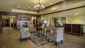 A spacious lobby with a fireplace, comfortable seating, and a chandelier. - Branson Condo at Pointe Royale with Indoor Pool and Hot Tub walking distance to (Branson)