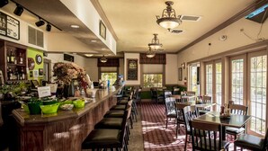 A restaurant with a bar area, multiple tables, and chairs. - Branson Condo at Pointe Royale with Indoor Pool and Hot Tub walking distance to (Branson)