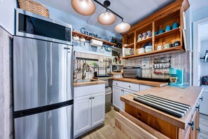 Enjoy cooking in this well-equipped kitchen with stainless steel appliances, a central island, and ample storage.
