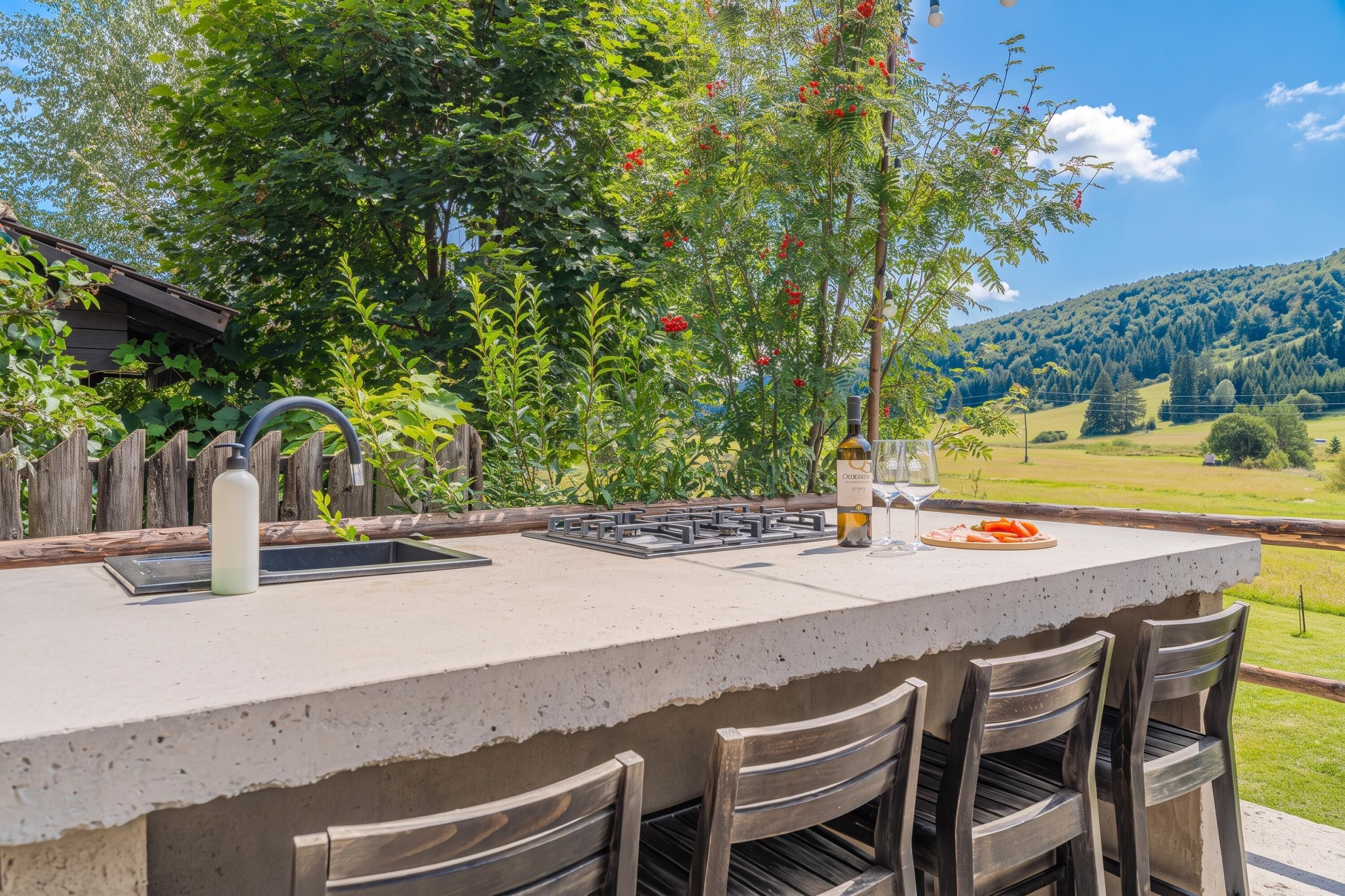 An outdoor kitchen with a built-in bar area, a sink, and a wine bottle.