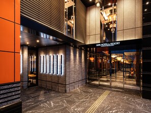 The exterior of APA Hotel & Resort with a modern design, featuring a glass entrance and a patterned facade. - APA Hotel & Resort Hakata Ekihigashi (Fukuoka)