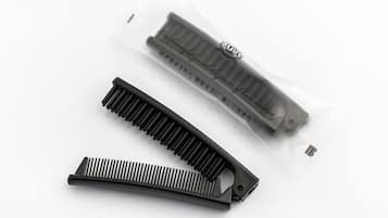 A black comb and a comb case with text on it.