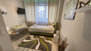 Une chambre à coucher moderne avec un lit, un bureau et une chaise.