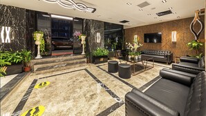 A modern lobby with a marble floor, leather sofas, and a flat-screen TV mounted on the wall. - The Halich Hotel Istanbul Karakoy (Istanbul)