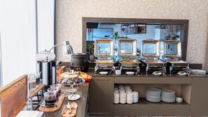 A buffet setup with various food stations, including a coffee station and a fruit display. - The Halich Hotel Istanbul Karakoy (Istanbul)