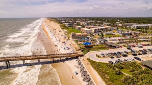 A coastal hotel with a beach view, a parking lot, and a boardwalk over the water. - Homewood Suites by Hilton St. Augustine San Sebastian (St. Augustine)