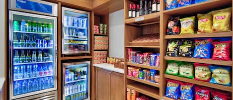 A snack and beverage section with refrigerated drinks, snacks, and condiments.
