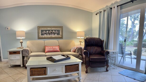 A living room with a sofa, armchair, coffee table, and lamps. - A3 Pet friendly, 1 BR, 1 BA, with tile floors Ask about long term rates (St. Simons Island)
