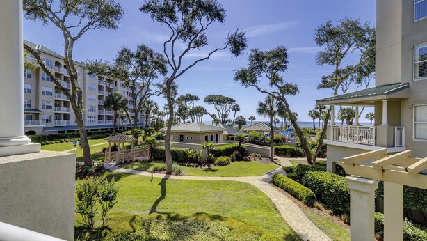 A resort with multiple-story buildings, manicured lawns, and palm trees. - 6101 Hampton Place-Modern meets the Beach in this Oceanfront Escape! (Hilton Head Island)