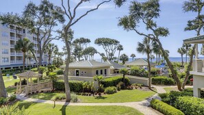 A resort with multiple buildings, a well-maintained lawn, and a clear view of the ocean. - 6101 Hampton Place-Modern meets the Beach in this Oceanfront Escape! (Hilton Head Island)
