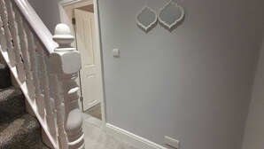 A staircase with white balusters and a door at the top. - Breeze on Southend in Essex (Southend-on-Sea)