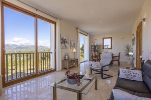 A spacious living area with a balcony, a dining table, and a sofa. - Modern villa with 3 bedrooms, 2 bathrooms, wifi, terraces and pool (Inca)