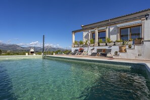 A clear swimming pool with lounge chairs and potted plants on a terrace, overlooking a mountainous landscape. - Modern villa with 3 bedrooms, 2 bathrooms, wifi, terraces and pool (Inca)