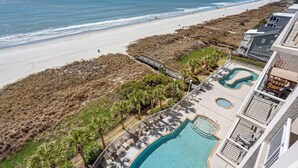A beachfront hotel with a swimming pool, beach access, and a view of the ocean. - Show-stopping views at this oceanfront condo w/indoor & outdoor pools, lazy river, kids' pool (North Myrtle Beach)