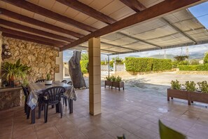 Enjoy al fresco dining under a shaded roof with a scenic view.