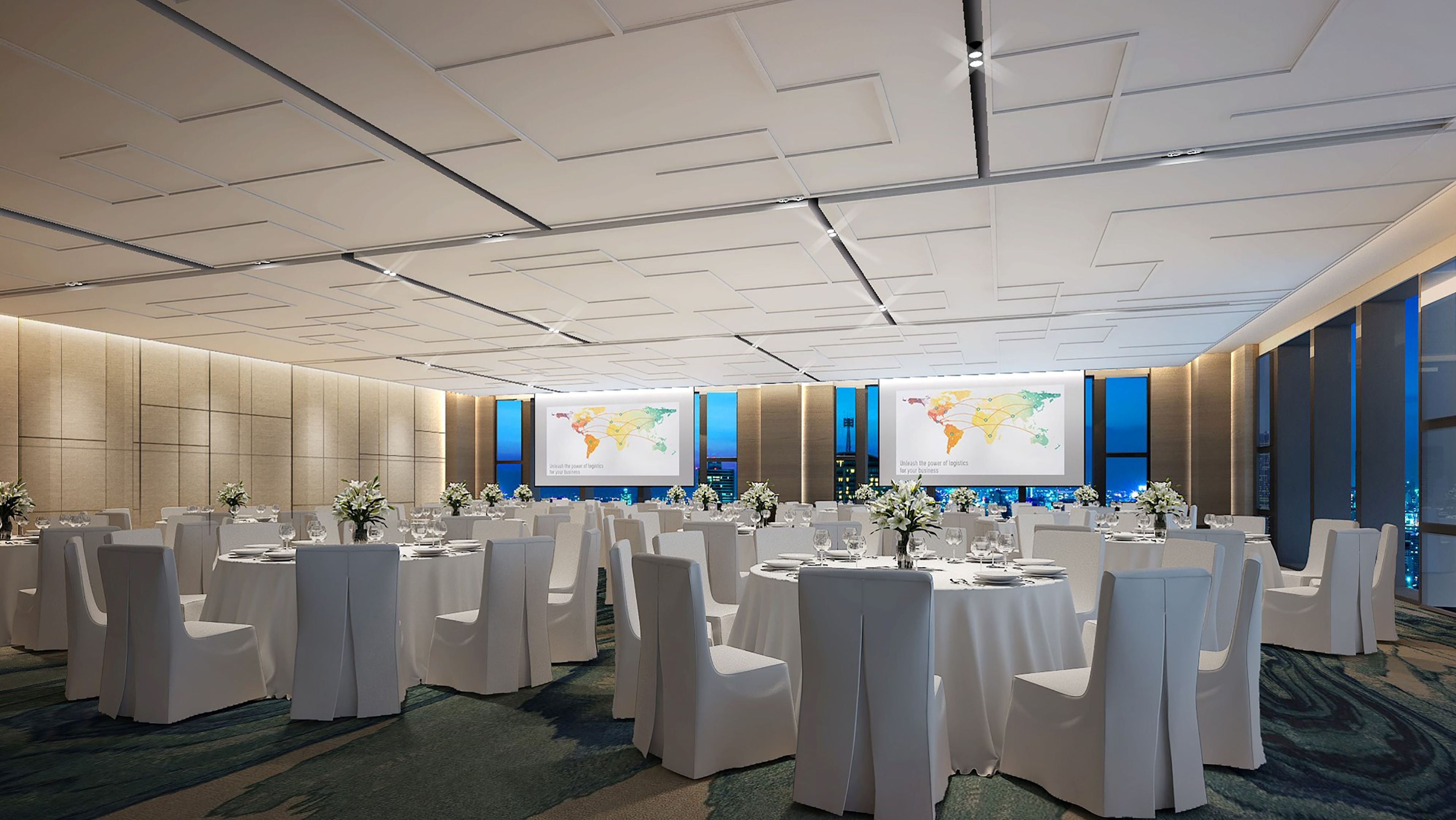 A conference room with round tables, white chairs, and large screens displaying maps.
