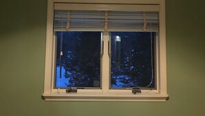 A room with a skylight window and a standard window with blinds. - Spacious House near Lake and Snowmobile Trails (Piseco)