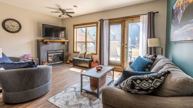 A living room with a fireplace, a sofa, a coffee table, and a television.