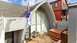 A deck with a barbecue, outdoor seating, and a flag. - 6 Bedroom + 2 Den Duplex 2 Blocks from PC Mountain! Can't beat this place! (Park City)