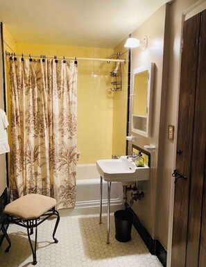 Bathtub, hair dryer, towels, soap - Craftsman Style Brick Cottage 1937 downstairs apartment (Tryon)