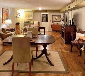 Relax in a classic living room with a large dining table, comfortable sofa, and traditional decor.