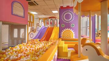 A children's play area with multiple slides and a ball pit.