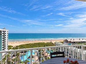 A resort with a beach view, a pool area, and a building with balconies.