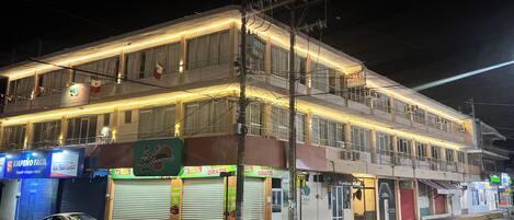 A multi-story hotel with balconies, a visible sign for 'Las Brisas', and closed shop fronts.