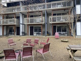 A multi-story building with outdoor seating and a covered patio area.