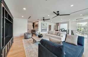 A modern living room with a sofa, coffee table, and a television.