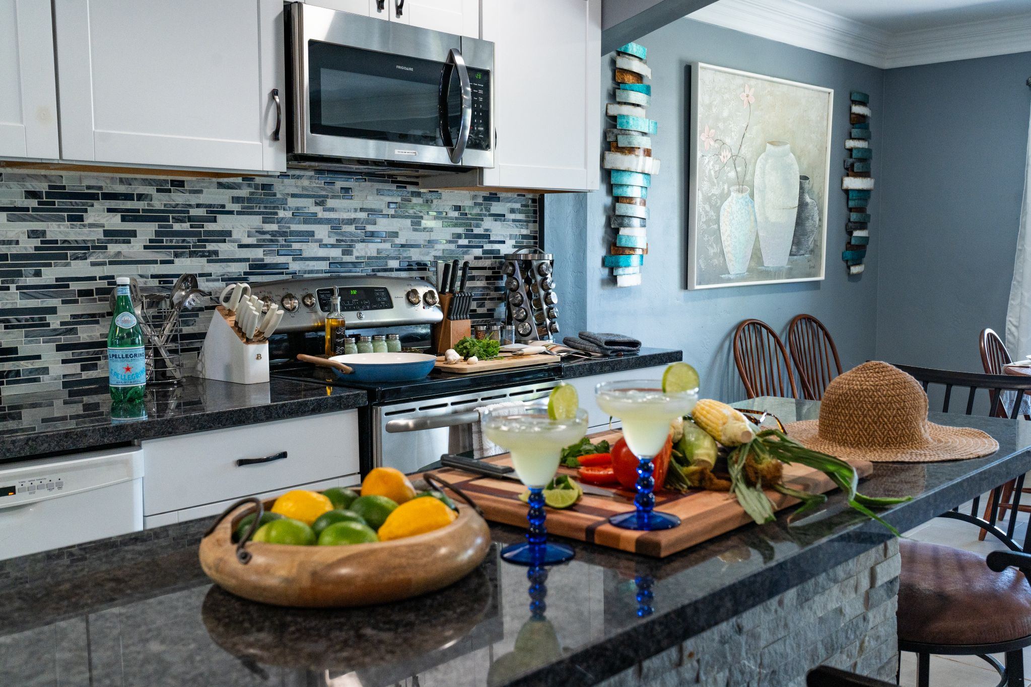 A modern kitchen with a microwave, stove, and various kitchen utensils.