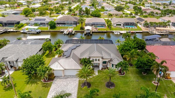 A residential area with houses, a canal, and a boat dock.